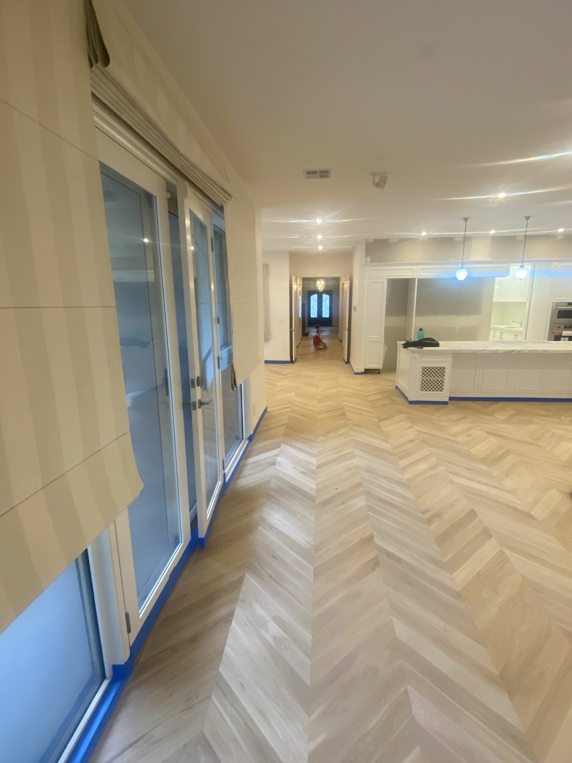 Light natural oak herringbone floor running through a hallway