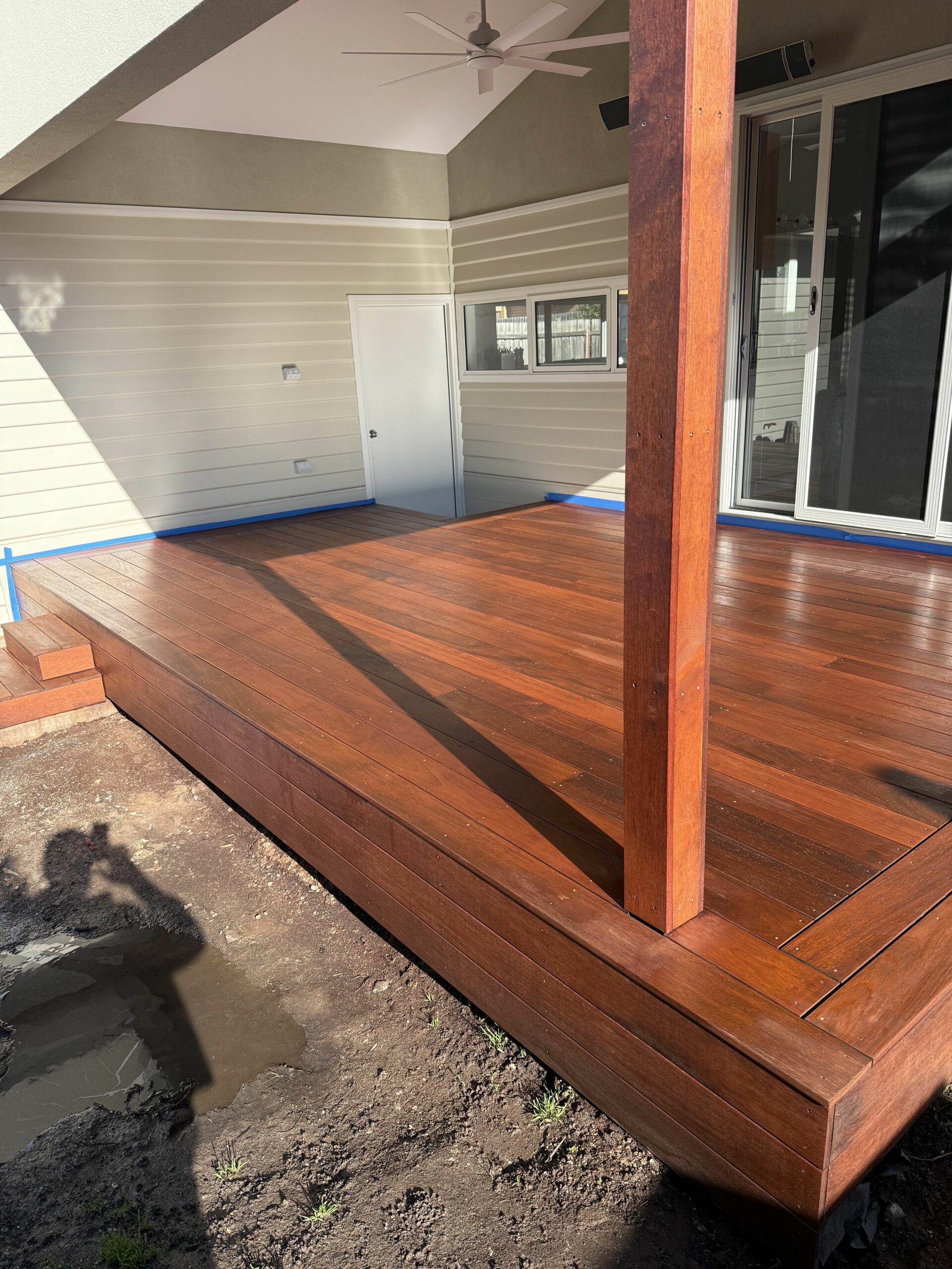 Freshly oiled hardwood timber deck with a rich red-brown finish